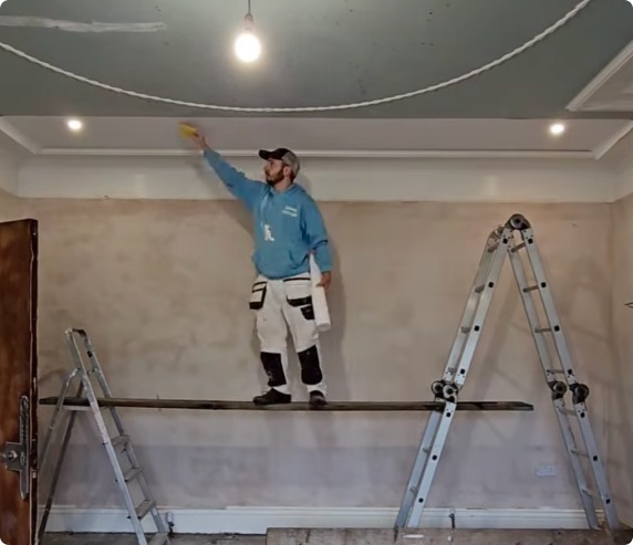 Dan painting a wall