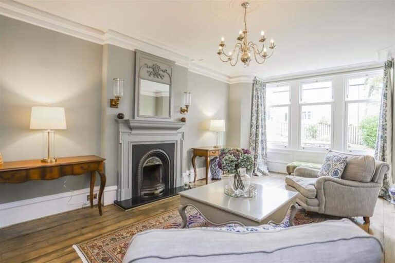 Freshly decorated living room with period fireplace