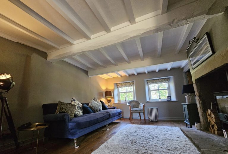 Redecorated front room with beamed ceiling